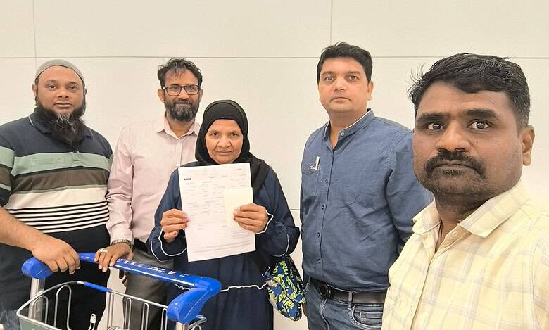 Community members holding documents and a shopping cart in an indoor setting, representing social activis.