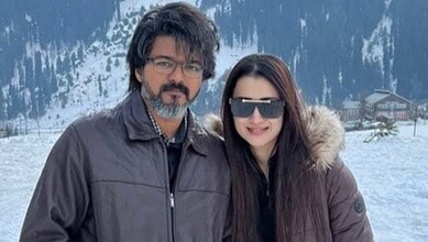 Vijay and Trisha in snowy landscape, celebrating political milestone and personal love.