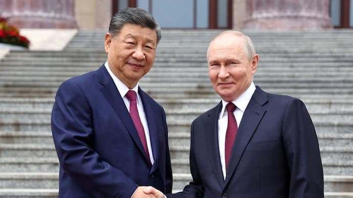 Chinese President Xi Jinping shakes hands with Russian President Vladimir Putin during a meeting in Beijing.