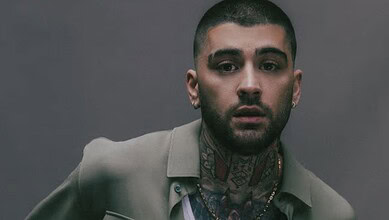 Zayn Malik with tattoos and serious expression, promoting tour update.