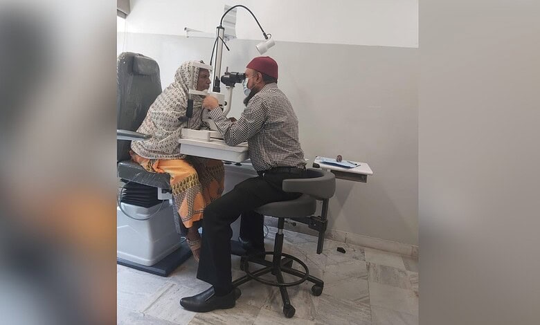 Eye examination at Abid Ali Khan Eye Hospital with doctor and patient using slit lamp.