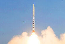 India launches Gaganyaan mission rocket into the sky with bright flames and smoke.