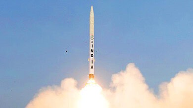 India launches Gaganyaan mission rocket into the sky with bright flames and smoke.