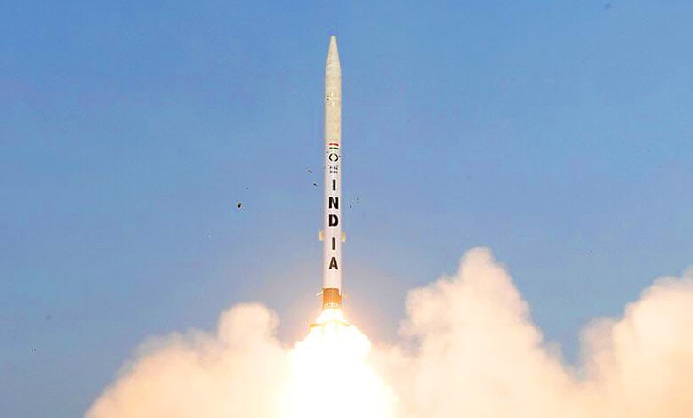 India launches Gaganyaan mission rocket into the sky with bright flames and smoke.