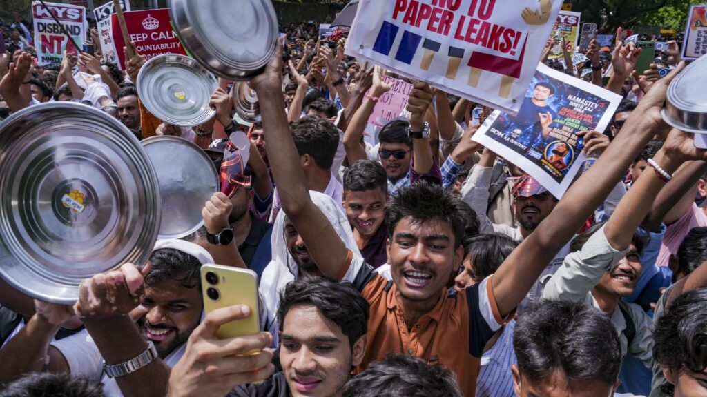 Protesters at Jantar Mantar holding signs and making noise during a demonstration.
