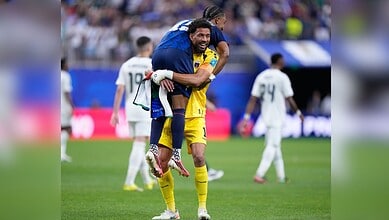 Celebrating football players on the field after a match at the FIFA World Cup.