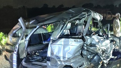 Damaged silver car after crash on NH-63 in Karnataka at night.