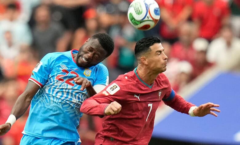 Cristiano Ronaldo and an opponent compete for the ball during a match.