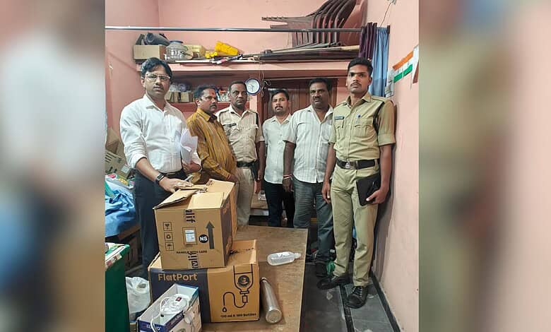 A group of men, including a police officer, standing inside a small room with boxes and supplies, possibl.