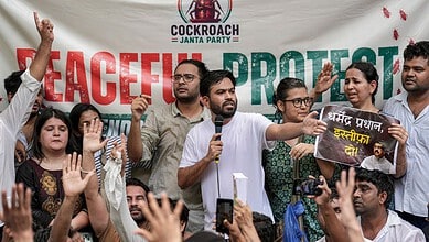Group of protesters holding signs and raising hands during a peaceful protest against cockroach Janta Par.