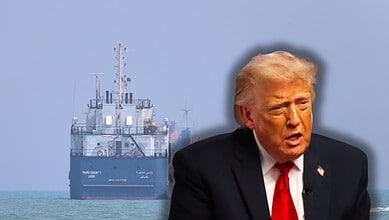 A man resembling Donald Trump speaking with a large ship in the background on the sea.