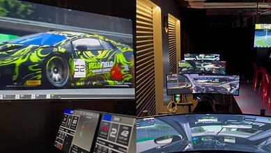 Vivid race car graphics showcased on multiple screens in a racing simulation room.
