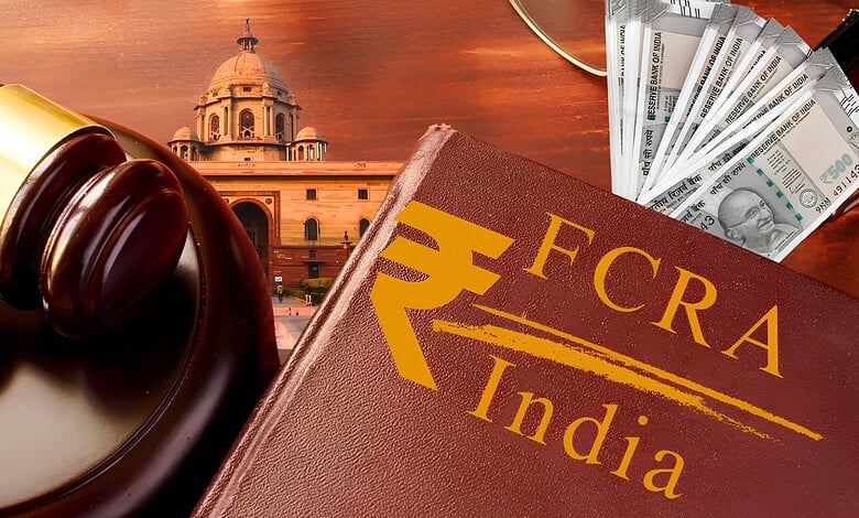 Gavel, FCRA India book, and Indian currency notes on a table.