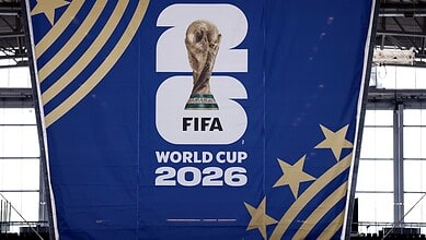 FIFA World Cup 2026 promotional banner with logo and stars at an indoor venue.