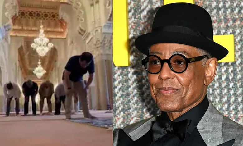Giancarlo Esposito wearing a black hat and glasses at an event.