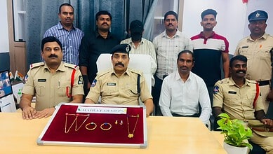 Police officers and officials display seized gold jewellery in Hyderabad.
