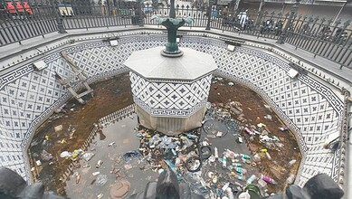 Fountain in Hyderabad's Gulzar Houz filled with garbage and plastic waste.