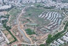 Aerial view showing Hyderabad lakes being restored with construction and greenery, part of Rs 107 crore project.