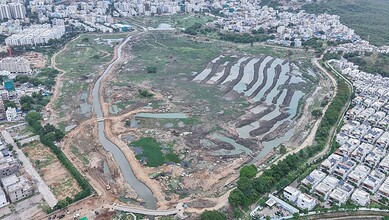 Aerial view showing Hyderabad lakes being restored with construction and greenery, part of Rs 107 crore project.