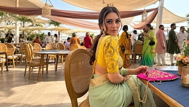 Hansika in traditional attire at Charminar, surrounded by fans and media, during shooting for a film.