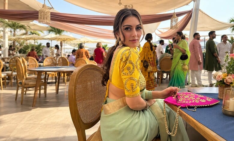 Hansika in traditional attire at Charminar, surrounded by fans and media, during shooting for a film.