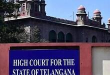 Telangana High Court building with historic architecture and domes, sign visible in the foreground.