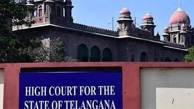 Telangana High Court building with historic architecture and domes, sign visible in the foreground.