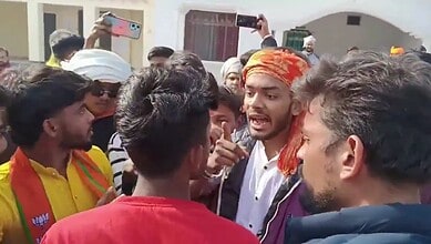 Hindu youth shouting and protesting, surrounded by a crowd, during a tense confrontation.