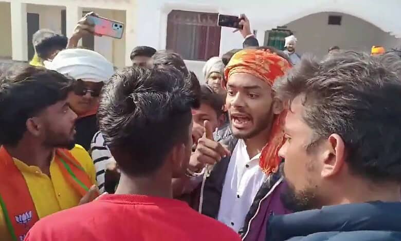 Hindu youth shouting and protesting, surrounded by a crowd, during a tense confrontation.