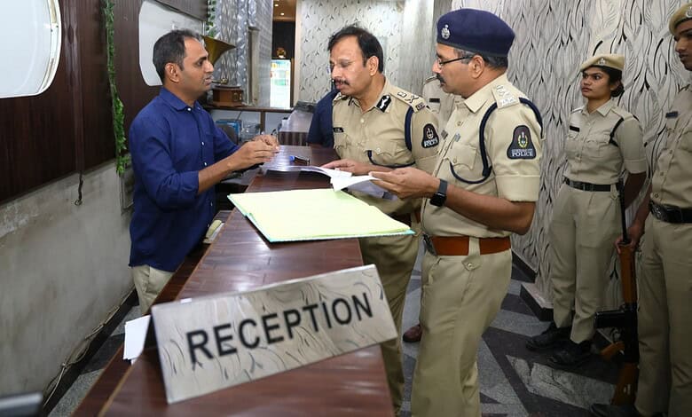 Police officers engaging with a visitor at the reception desk in a government or institutional setting.