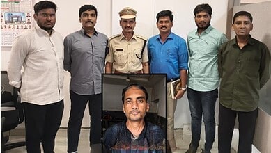 A man in a black shirt is photographed with six men, including a police officer, in an indoor setting.