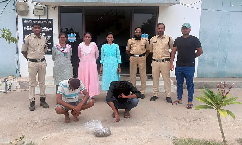 A woman and a man kneeling on the ground with a bag of items, surrounded by police officers and other ind.