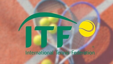 International Tennis Federation logo with tennis racket and ball on clay court background.