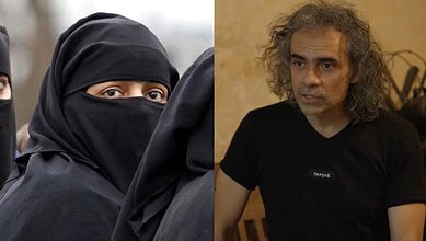 Close-up of a woman in a black burqa with only her eyes visible.
