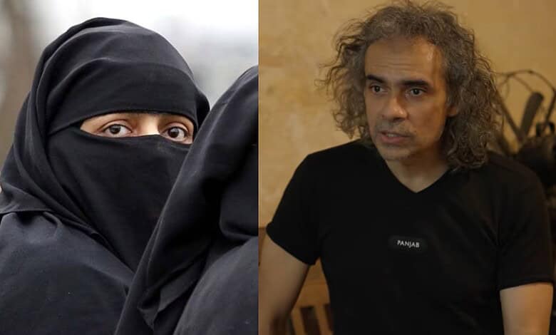 Close-up of a woman in a black burqa with only her eyes visible.