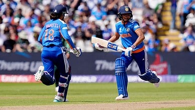 A cricket players celebrating on the field during a match in India.