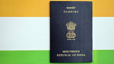 Indian passport with national flag background, official travel document of India.