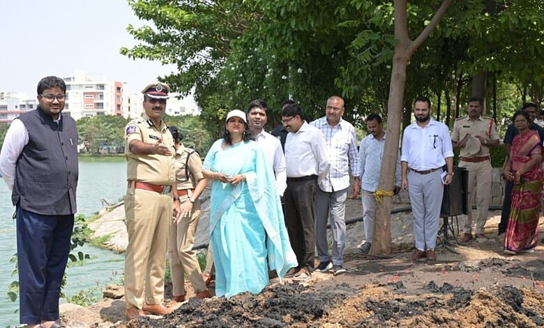 Community leaders and officials gather by the water for an environmental event in Hyderabad.
