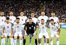 Iran national football team players before a match, team lineup on the field.