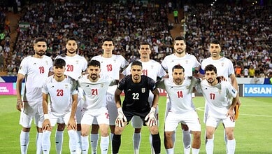 Iran national football team players before a match, team lineup on the field.