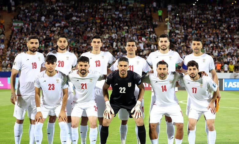 Iran national football team players before a match, team lineup on the field.