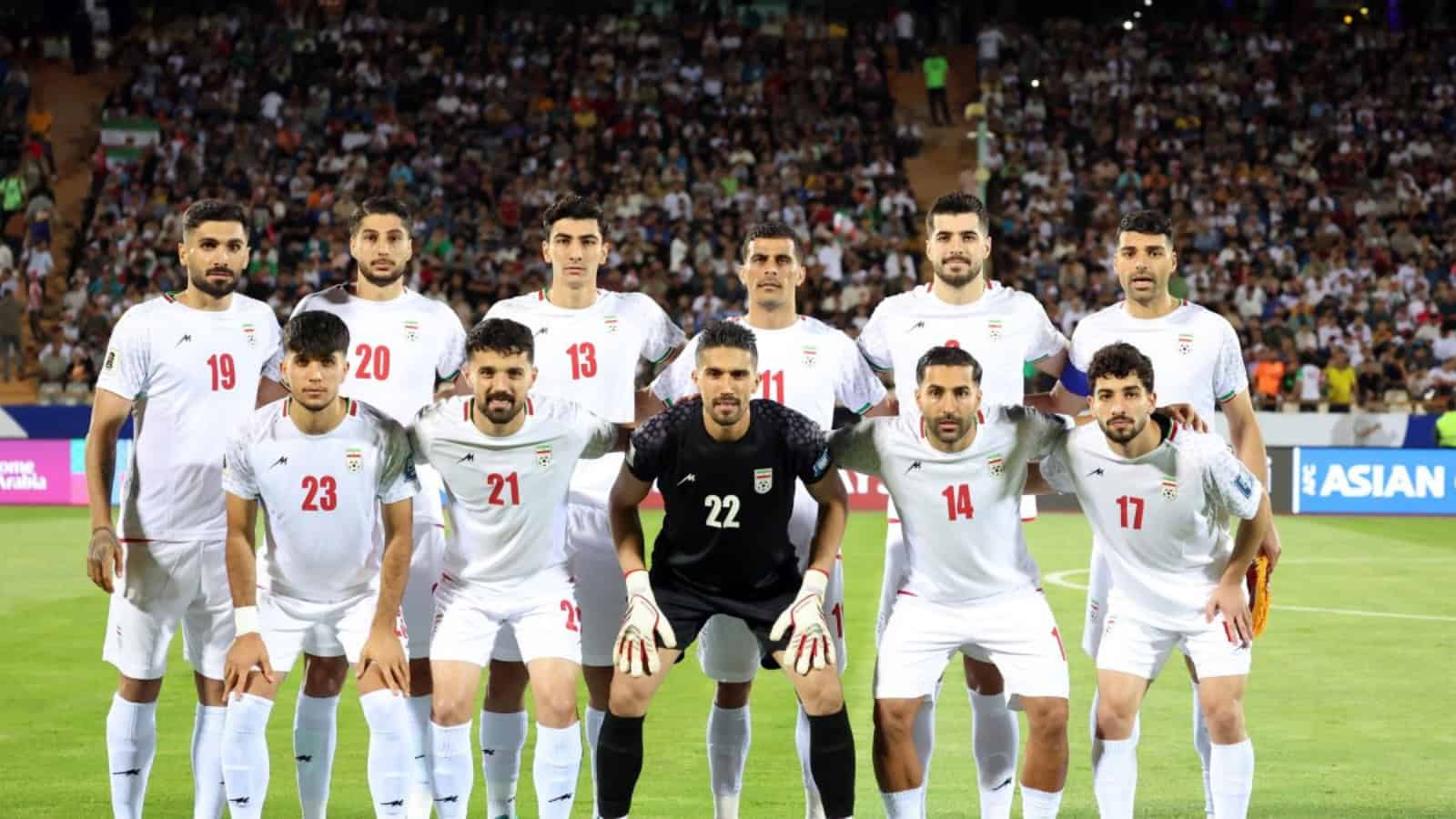 Iran national football team players before a match, team lineup on the field.