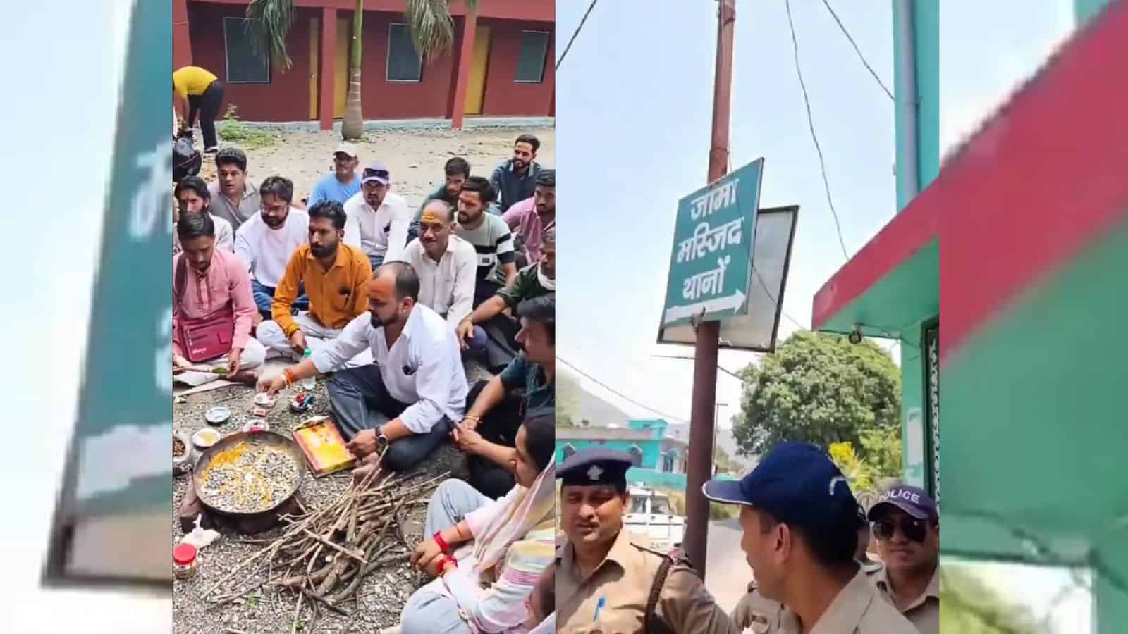 A group of people sitting on the ground around a traditional fire cooking setup outdoors, with police off.