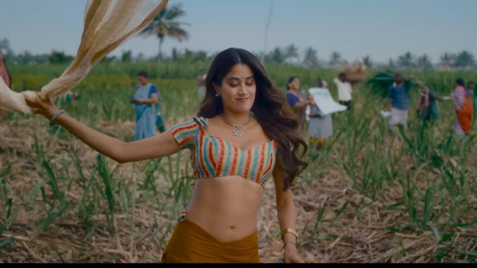 Woman dancing joyfully in a vibrant field with farmers and greenery in the background.