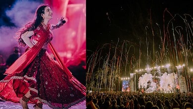 Jasmine Sandlas performing on stage at Hyderabad concert with fireworks in background.