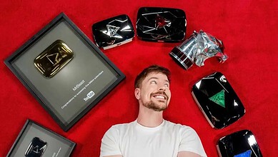 YouTube Silver Play Button award displayed with a man smiling and looking up on a red background.