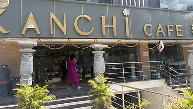 Kanchi Cafe in Manikonda, Hyderabad, with festive decorations and a person entering the cafe.