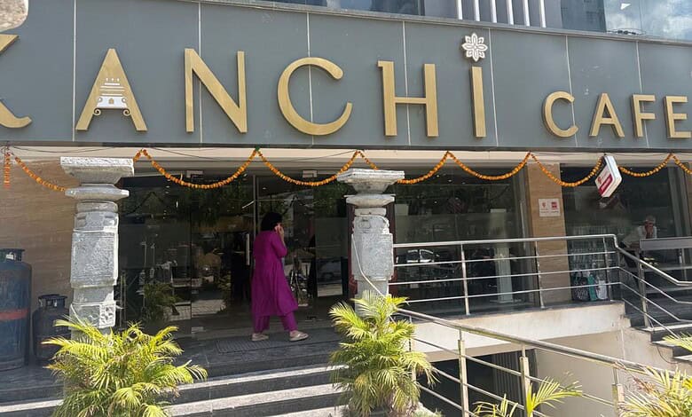 Kanchi Cafe in Manikonda, Hyderabad, with festive decorations and a person entering the cafe.