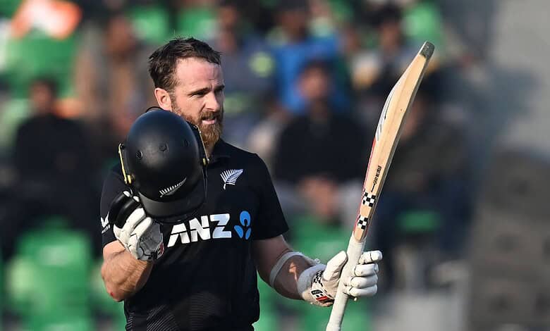 A cricket player celebrating after scoring a century during a match.