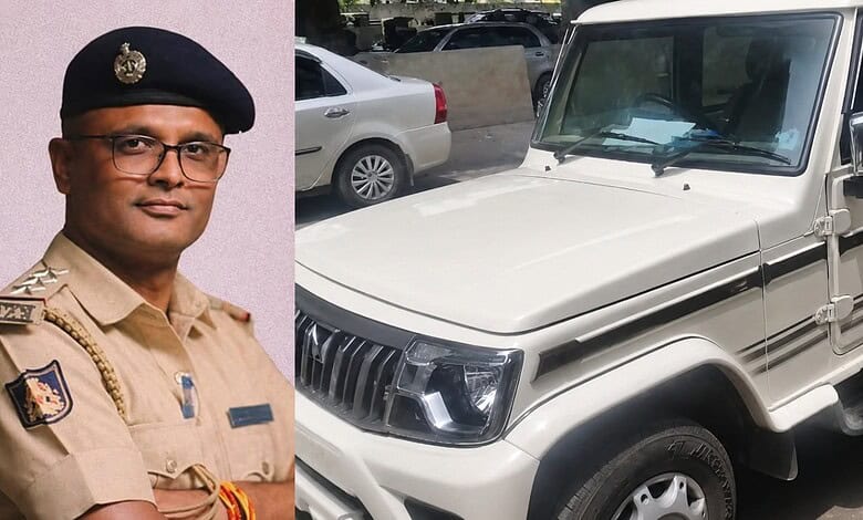 Kerala police officer in uniform standing next to a white vehicle.